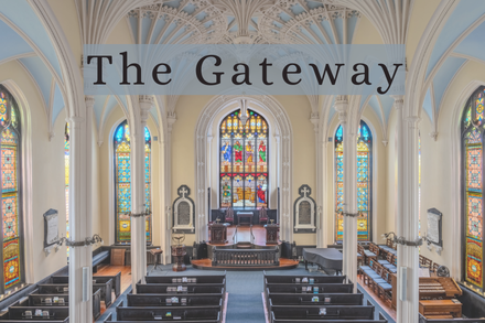 Interior view of a beautifully ornate church with stained glass windows and vaulted ceilings.